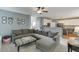 Spacious living room with large sectional sofa flowing into kitchen area with breakfast bar and white cabinetry at 1641 Rocky Knoll Ln, Dacula, GA 30019