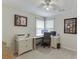 Bright office features a ceiling fan and desk with computer setup at 1641 Rocky Knoll Ln, Dacula, GA 30019