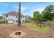 Large backyard with a fire pit, playground, patio seating, and lush green lawn at 2263 Seatton Ct, Marietta, GA 30062