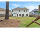 Spacious backyard features a patio with seating, play structure, and mature trees at 2263 Seatton Ct, Marietta, GA 30062