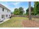 Scenic backyard with a playset, green lawn, patio, and a charming white house at 2263 Seatton Ct, Marietta, GA 30062