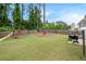 Fenced backyard showcasing a grassy lawn, playset, barbecue grill, and mature trees at 2263 Seatton Ct, Marietta, GA 30062
