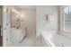 Bathroom featuring a white vanity with marble countertop, soaking tub, and neutral paint at 2263 Seatton Ct, Marietta, GA 30062