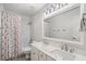 Bathroom with a large mirror above a double vanity and a tub with a shower and stylish curtain at 2263 Seatton Ct, Marietta, GA 30062