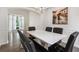 Elegant dining room features a white table with black chairs and bench seating, illuminated by a stylish chandelier at 2263 Seatton Ct, Marietta, GA 30062