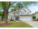 Inviting traditional two-story home featuring a well-maintained lawn, two-car garage, and a charming blue front door at 2263 Seatton Ct, Marietta, GA 30062