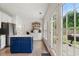 Bright kitchen with stainless steel appliances, blue island, and door leading to backyard at 2263 Seatton Ct, Marietta, GA 30062