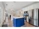 Bright kitchen featuring a blue island, stainless steel appliances, and sleek hardwood floors at 2263 Seatton Ct, Marietta, GA 30062