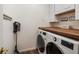 Convenient laundry room with a washer, dryer, and wood countertop at 2263 Seatton Ct, Marietta, GA 30062