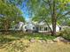 This backyard features a beautiful lawn with mature trees and landscaping at 4045 Fawn Valley Dr, Loganville, GA 30052
