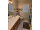 Cozy bathroom with oak vanity, white sink, and tiled floors at 4045 Fawn Valley Dr, Loganville, GA 30052
