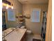 Bathroom with wood cabinet, oval sink, decor, and natural lighting at 4045 Fawn Valley Dr, Loganville, GA 30052