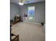 Neutral bedroom featuring a ceiling fan, a window, and gray-painted walls at 4045 Fawn Valley Dr, Loganville, GA 30052