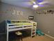 Bedroom with custom dinosaur themed decoration, grey walls, and a ceiling fan at 4045 Fawn Valley Dr, Loganville, GA 30052