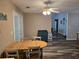 Cozy dining area featuring wood table and chairs and with natural light and modern ceiling fan at 4045 Fawn Valley Dr, Loganville, GA 30052