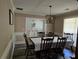 Traditional dining room with seating for six, decorative chandelier, and stylish wainscotting at 4045 Fawn Valley Dr, Loganville, GA 30052