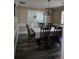 Cozy dining room with traditional furniture, decorative molding, and natural light from nearby windows at 4045 Fawn Valley Dr, Loganville, GA 30052