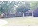 Beautiful front yard featuring a well-manicured lawn, mature trees, and a charming brick home exterior at 4045 Fawn Valley Dr, Loganville, GA 30052