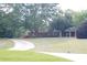 Serene front yard view showcasing lush greenery, a circular driveway, and a glimpse of the charming home exterior at 4045 Fawn Valley Dr, Loganville, GA 30052