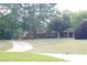 Landscaped front yard with mature trees, a circular driveway, and a view of the charming home exterior at 4045 Fawn Valley Dr, Loganville, GA 30052