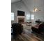 Vaulted ceiling living room boasts a brick fireplace, ceiling fan, and plank flooring at 4045 Fawn Valley Dr, Loganville, GA 30052
