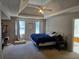 Spacious main bedroom with trey ceiling, fan, and natural light from two windows at 4045 Fawn Valley Dr, Loganville, GA 30052