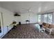 A cozy sunroom features a ceiling fan, and sitting area for relaxing at 4045 Fawn Valley Dr, Loganville, GA 30052