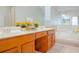 Bathroom features a double vanity, white countertops, a large mirror, and a separate soaking tub at 1166 Memory Ln, Lawrenceville, GA 30044