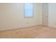 Bedroom with neutral walls and carpeting, door, and a window providing plenty of natural light at 1166 Memory Ln, Lawrenceville, GA 30044