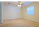 Cozy bedroom featuring plush carpeting, a window, and a ceiling fan for added comfort at 1166 Memory Ln, Lawrenceville, GA 30044