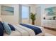 Stylish bedroom with coastal themed decor, beach artwork, and a comfortable bed with throw pillows at 1166 Memory Ln, Lawrenceville, GA 30044