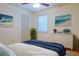 Bright bedroom with ceiling fan, beach themed artwork, and a comfortable bed with decorative pillows at 1166 Memory Ln, Lawrenceville, GA 30044