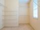 Walk-in closet with built-in shelving for ample storage and organization, plus a window for natural light at 1166 Memory Ln, Lawrenceville, GA 30044