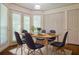 Dining room with natural wood table, seating for six, and modern lighting at 1166 Memory Ln, Lawrenceville, GA 30044