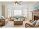Bright living room with stone fireplace, ceiling fan, and lots of natural light at 1166 Memory Ln, Lawrenceville, GA 30044