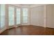 Bright room features a closet, double doors to the exterior, and luxury vinyl tile flooring at 1166 Memory Ln, Lawrenceville, GA 30044