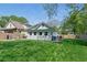 Large, grassy backyard with a well-maintained lawn, picnic table, and surrounding fence at 1292 Eubanks Ave, Atlanta, GA 30344