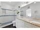 Modern bathroom with double sinks, a granite countertop, and a tiled walk-in shower at 1292 Eubanks Ave, Atlanta, GA 30344