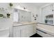 Bright bathroom featuring double sinks, granite countertop, tiled backsplash, and a soaking tub at 1292 Eubanks Ave, Atlanta, GA 30344