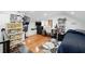 Cozy bedroom with hardwood floors, modern shelving, TV, desk, and a comfortable blue bedspread at 1292 Eubanks Ave, Atlanta, GA 30344