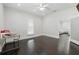 Well-lit bedroom with neutral walls, dark hardwood floors, and access to the main living area at 1292 Eubanks Ave, Atlanta, GA 30344