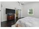 Relaxing bedroom showcasing dark wood floors, a sliding door, and a flat-screen television at 1292 Eubanks Ave, Atlanta, GA 30344