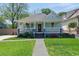 Charming home featuring a welcoming front porch, lush landscaping, and a well-manicured lawn at 1292 Eubanks Ave, Atlanta, GA 30344