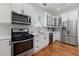 Modern kitchen featuring white cabinets, stainless steel appliances, and plenty of counter space at 1292 Eubanks Ave, Atlanta, GA 30344