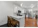 Well-lit kitchen with white cabinets, stainless steel appliances, and a breakfast bar with seating at 1292 Eubanks Ave, Atlanta, GA 30344