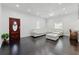 Open-concept living space with hardwood floors, a comfortable white sofa, and natural light at 1292 Eubanks Ave, Atlanta, GA 30344