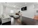Bright living room with hardwood floors, a modern white sofa, and an open layout to the kitchen at 1292 Eubanks Ave, Atlanta, GA 30344