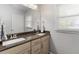 Bathroom features a double sink vanity, a large mirror, and a window for natural light at 2218 Edgemore Se Dr, Atlanta, GA 30316