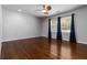Bright bedroom with hardwood floors, neutral walls, ceiling fan, and window with blue curtains at 2218 Edgemore Se Dr, Atlanta, GA 30316