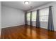 A bright bedroom with hardwood floors and natural light streaming through the three windows at 2218 Edgemore Se Dr, Atlanta, GA 30316
